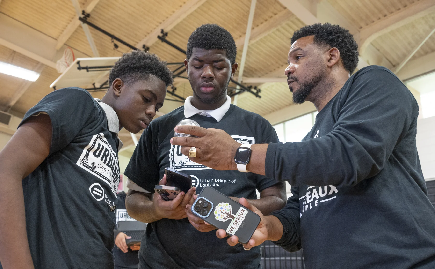 Wiley guiding two students through a hands-on robotics activity